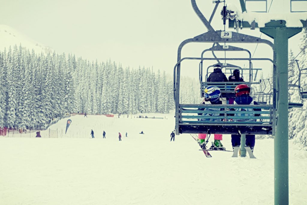 a family riding the chair lift at Marmot Basin in Jasper National Park