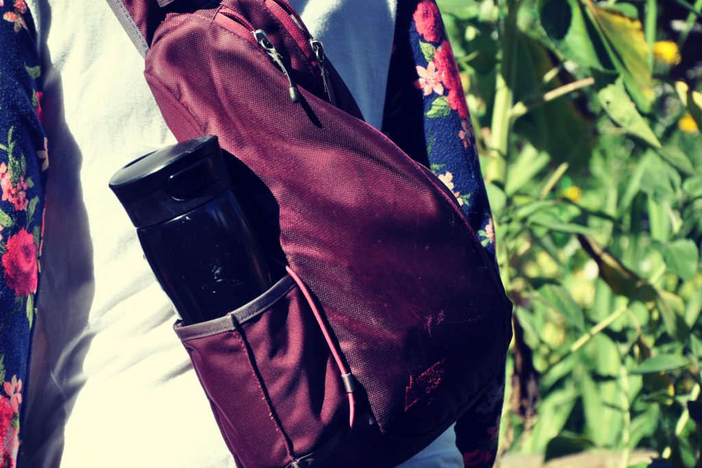 A woman wearing a purple cross-shoulder bag as her mom purse