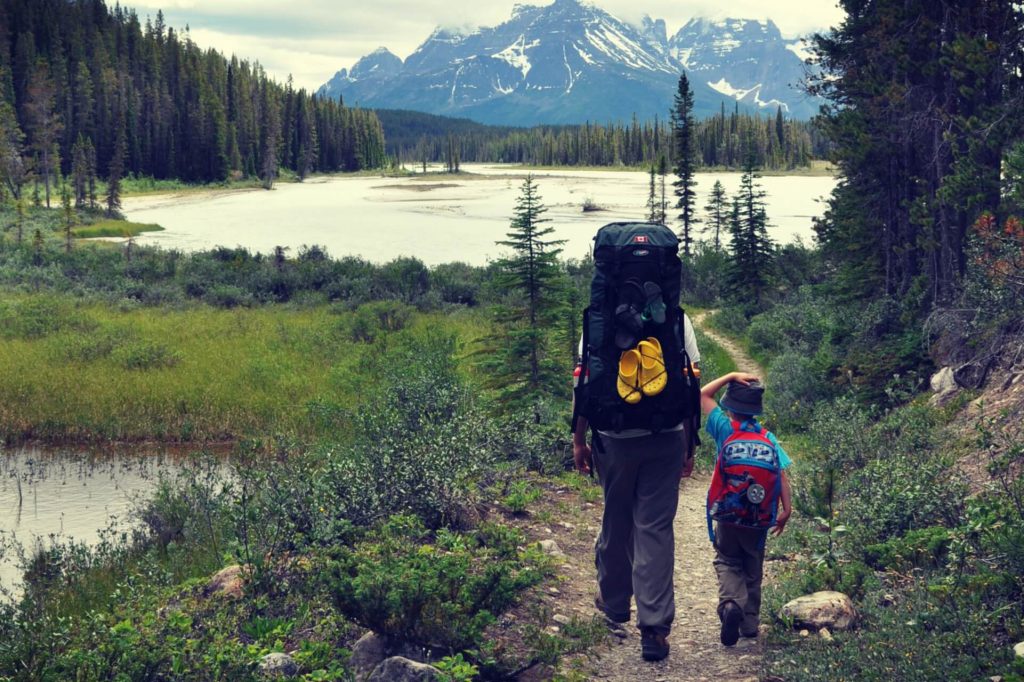 Father and son backpacking in the mountains