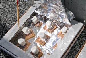 melting marshmallows and chocolate in a homemade solar oven