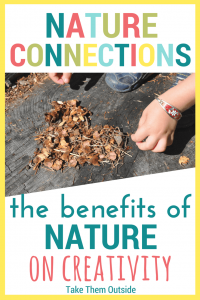 a small child's hands being creative outdoors by making a heart from pine cone pieces