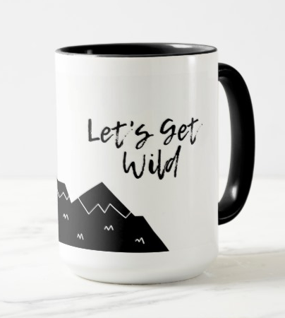 A white mug with black mountains and the words Let's Get Wild in script