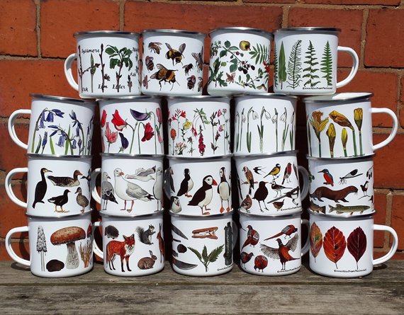 A variety of enamel mugs all printed with different plants and animals.