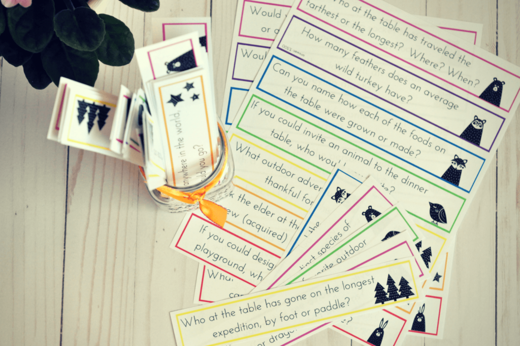 nature-themed family conversation cards cut and ready in a jar on a wooden table