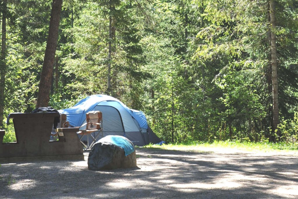 a blue tent in a campground