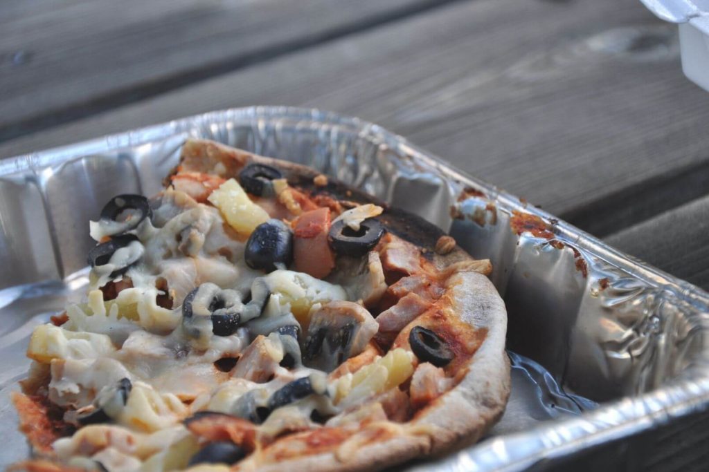 cooked pita camping pizza in a tinfoil pan