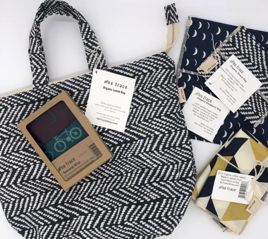 a handmade eco friendly lunch bag and reusable snack bags in matching greys and blacks