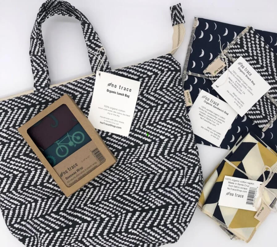 a handmade eco friendly lunch bag and reusable snack bags in matching greys and blacks