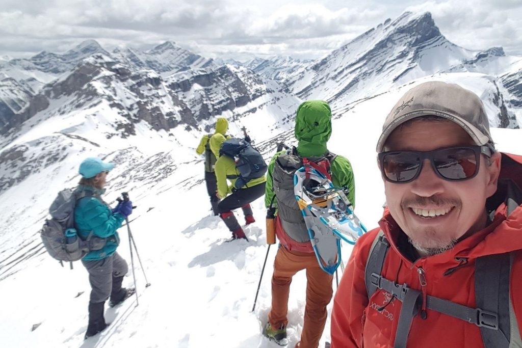 hikers on a snowy mountain top trail