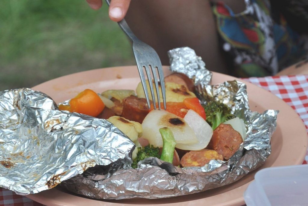 an opened foil pack on a camping dish