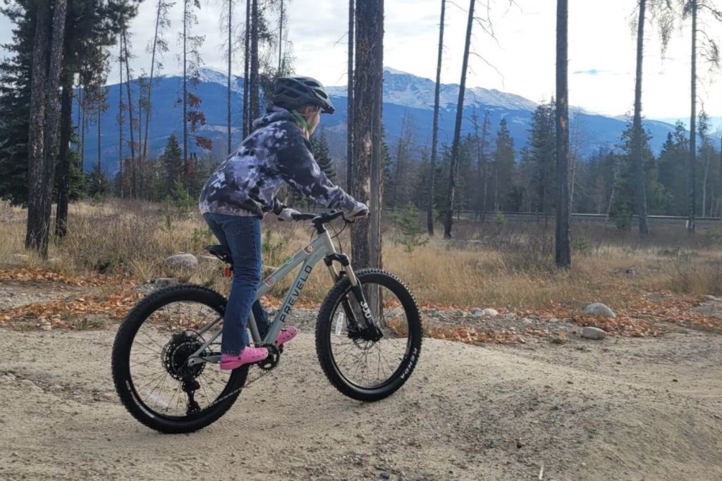 girl riding a mountain bike on a dirt trail