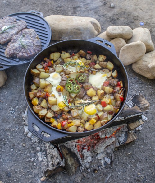 cast iron cooking set over a campfire