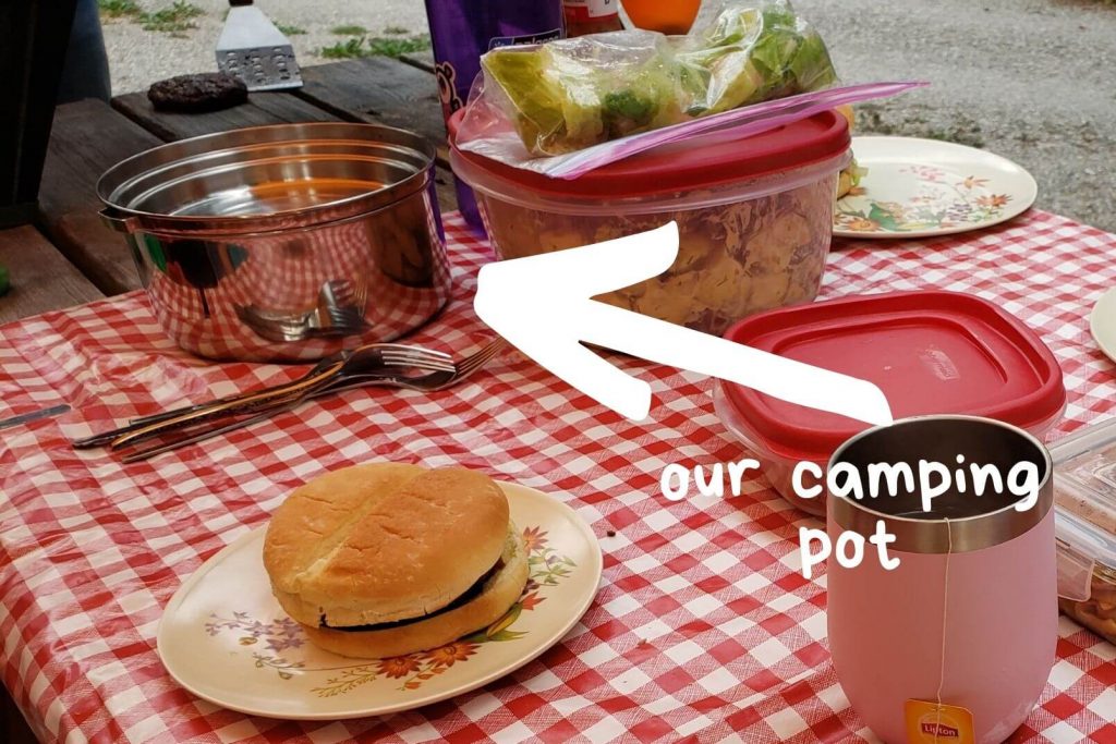camp dishes, camping cooking pot, and camp food on a red checkered table cloth