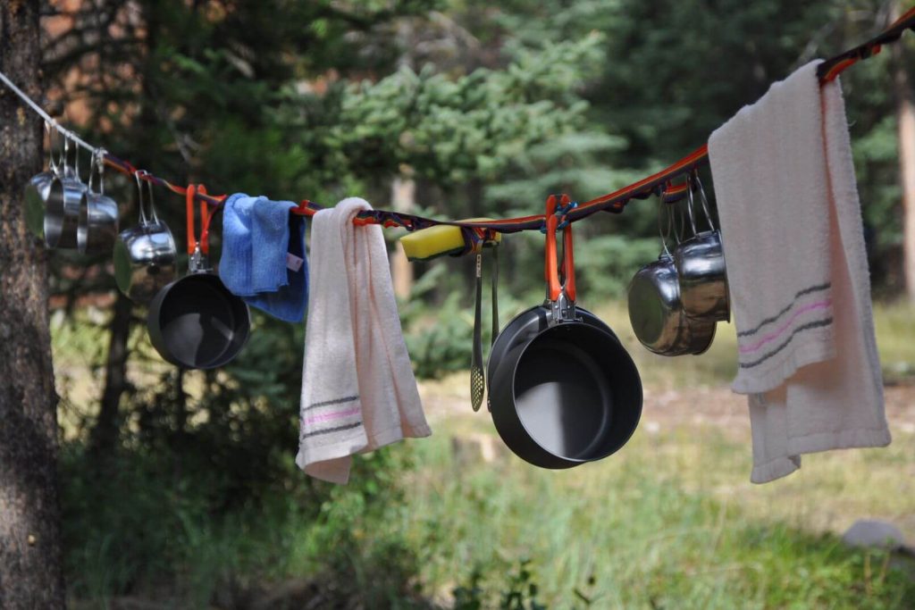 Camping pots and towels hanging outside on a drying line